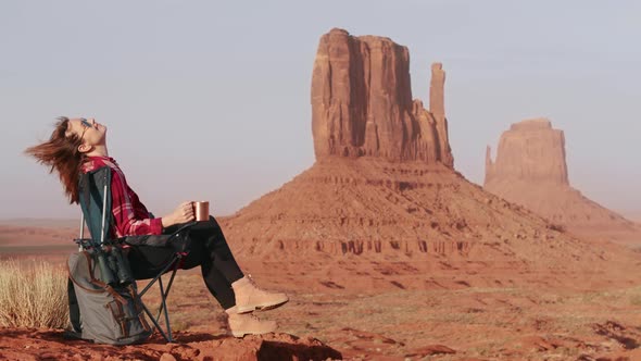 Happy Excited Woman Enjoying Cinematic View on Monument Valley at Sunset Light