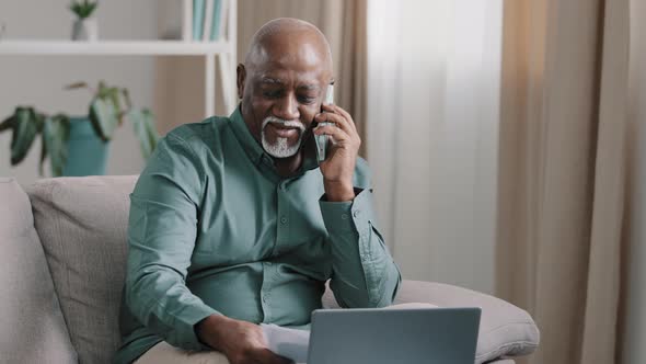 African Biracial Bald Old Man with Gray Beard Senior Mature Businessman Busy Employee Using Laptop
