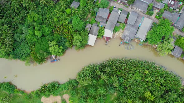 An aerial view over a fishing village by a canal in the countryside