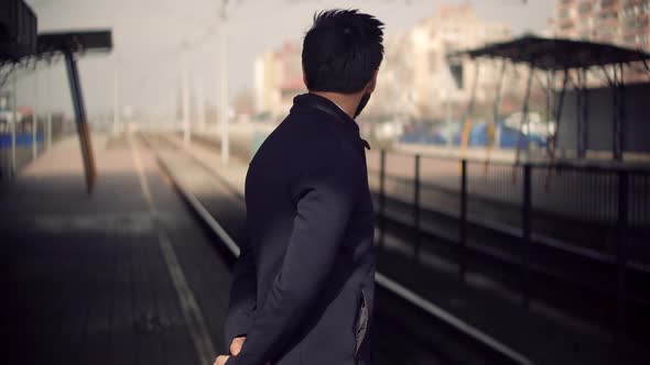 Businessman Hurries To Work And Standing On Railway Train Station Platform. Public Transport.