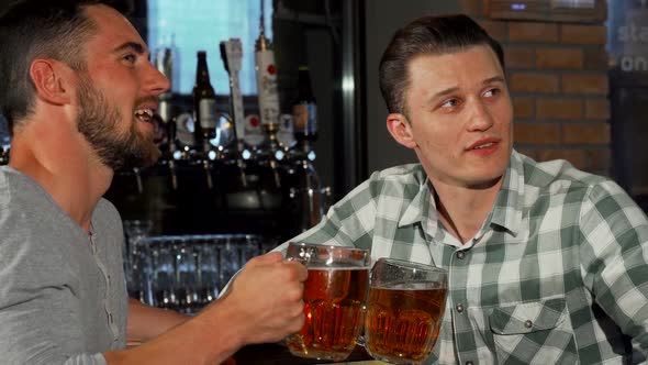 Cheerful Male Friends Watching a Game at the Bar While Having Beer 1080p