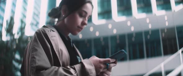 Woman walks and uses phone