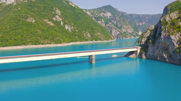 Aerial View on Bridge Over Lake Piva with Mountains in the Background in Montenegro