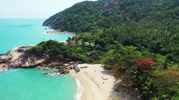 Aerial flying over nature of tranquil shore beach vacation by aqua blue ocean with white sandy backg