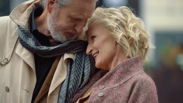 Elderly Couple Hugging Outdoors