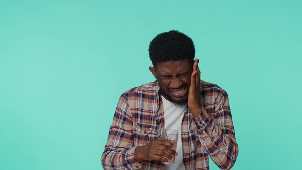 Man Touching Cheek Suffering From Toothache Cavities or Gingivitis Waiting for Dentist Appointment