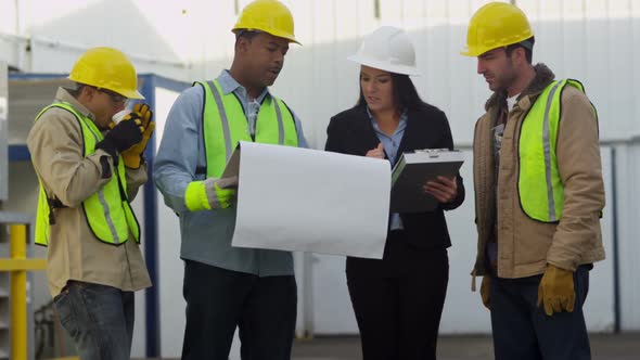 Commercial construction crew look over plans