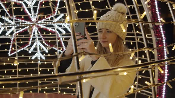 Woman Photographing Christmas Lights