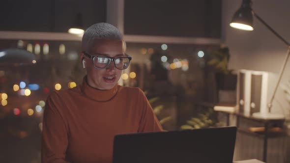 Businesswoman Speaking on Video Call on Laptop in Evening