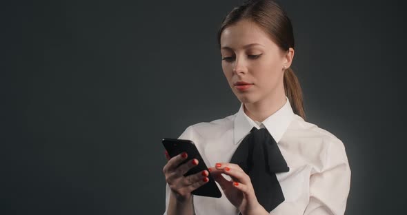 Dissatisfied European Woman Swipes the Screen of Smartphone in a Rush User Declines Messages and