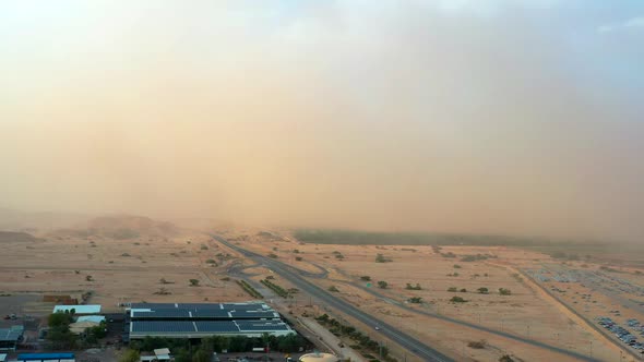 Large sandstorm sweeps over Highway 90 at Timna Park in Southern Arava on a clear summer day in Isra