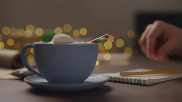 Slow Motion Orbit Shot Man Drinking Hot Chocolate From Blue Cup Evening Making Shopping List