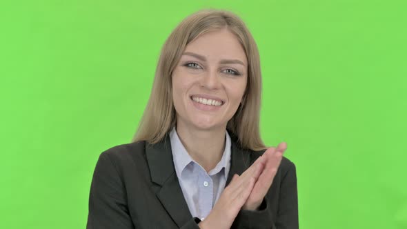Cheerful Young Businesswoman Doing Clapping Against Chroma Key