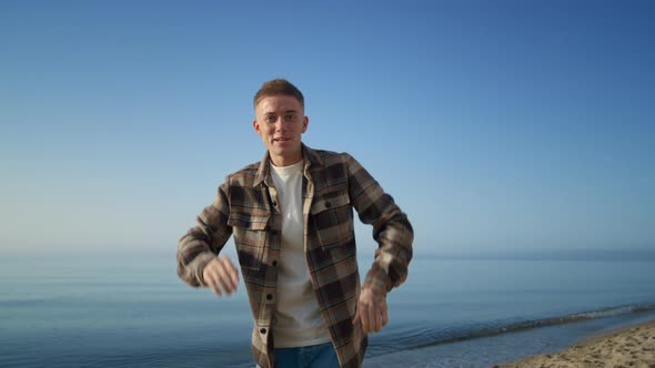 Positive Guy Say Hello on Camera Relaxing on Beach