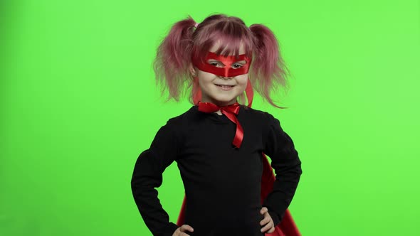 Funny Child Girl in Costume and Mask Plays Super Hero. National Superhero Day