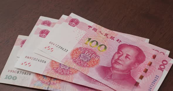 Counting chinese RMB banknote on the table