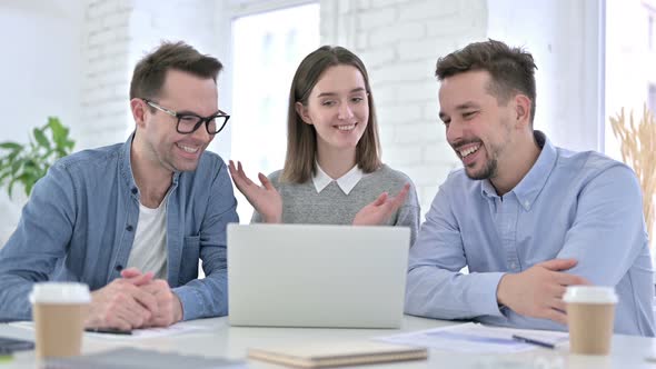 Cheerful Creative Team Doing Video Chat on Laptop