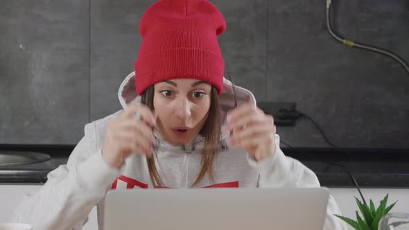 Happy Fun Beautiful Young Woman 20s in a Grey Sweatshirt Red Headwear