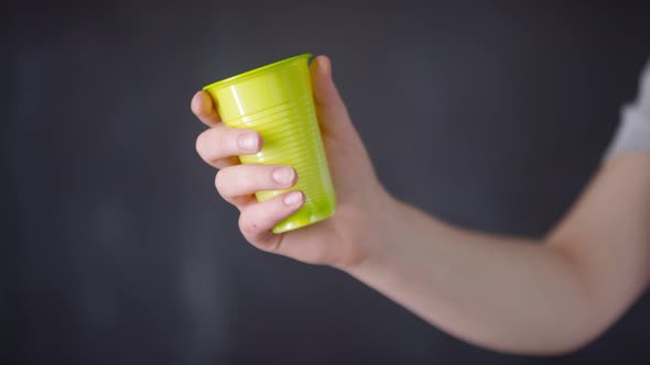 Crumpled Plastic Cup In Hands