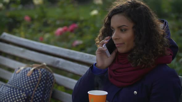 Smiling Female Student Talking Over Phone Making Appointment With Friends