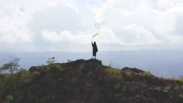 Aerial View of Shaman with Colorful Smoke Doing Ritual in Mountains