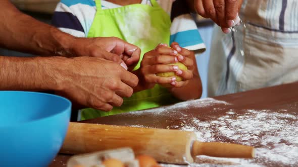 Multi-generation family preparing dessert in kitchen