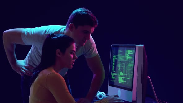 Man and woman working on computers