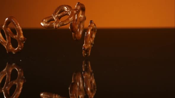 Pretzels falling and bouncing in ultra slow mo 1500fps - reflective surface - PRETZELS PHANTOM