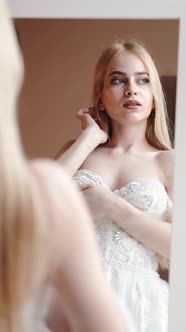 Young Blonde Woman in Elegant White Dress Posein Studio