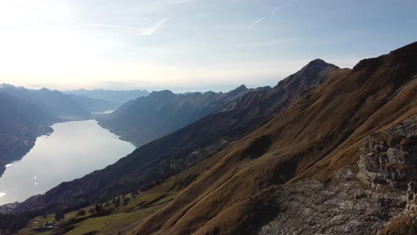 Drone view to green Mountains with a beautiful Swiss lake (Brienzersee)