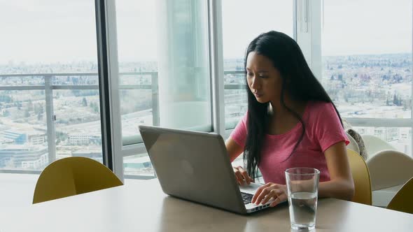 Woman using laptop in living room