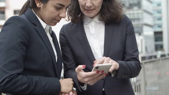 Businesswomen Using Smartphone on Street