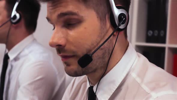 Two Employee with Headsets Talking on Voice Call Centre