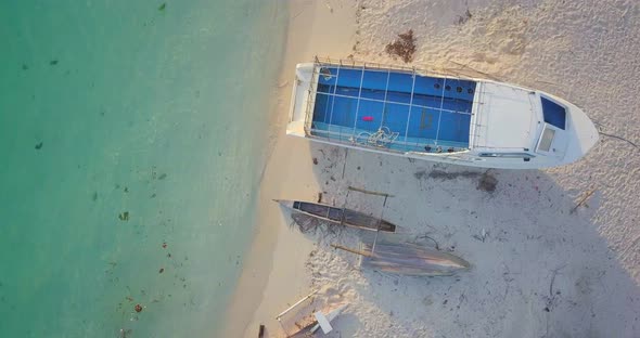 Aerial flight along the beach and crystal clear ocean in Mabul, Malaysia