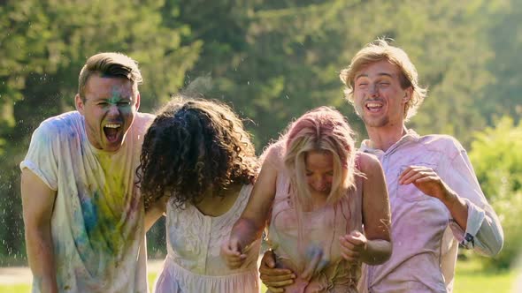 Group of Friends Covered in Colored Paint Enjoying Time at Summer Pool Party