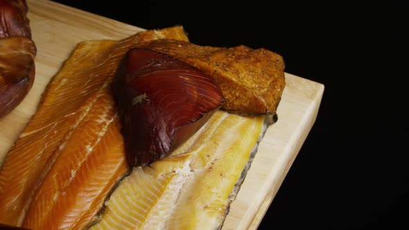 Rotating shot of a variety of delicious, premium smoked meats on a wooden cutting board - FOOD 077