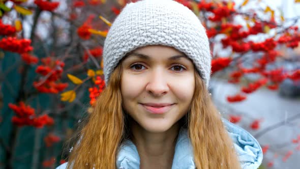 Blond Girl in Knitted Hat Poses at Rowan Tree Red Berries
