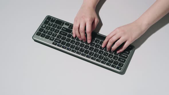 Crop person using computer keyboard