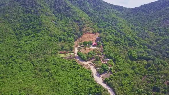 Drone Flies Over Mountain with Modern Road To Buddhists Temple