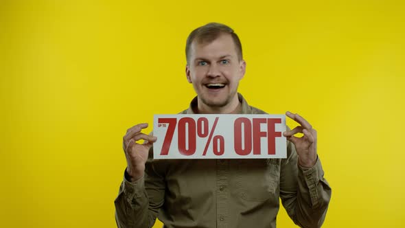 Attractive Man Showing Up To 70 Percent Off Inscriptions Signs, Rejoicing Good Discounts, Low Prices