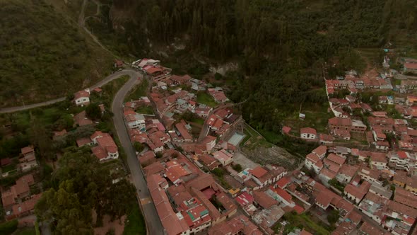 Dolly out and tilt up with a wide angle shot, 4K aerial drone view from Cusco and the famous white s