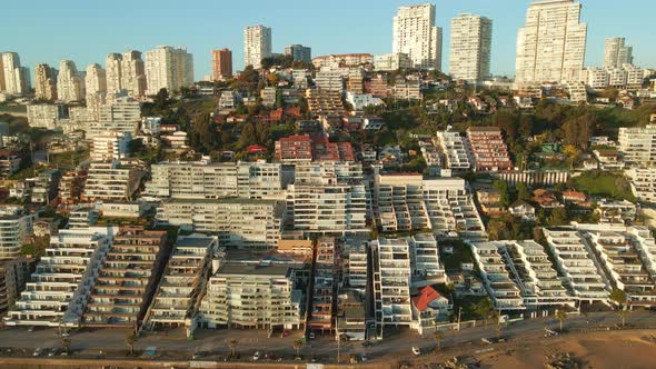 Aerial view forwards towards scenic Reñaca beach resort hotel buildings on Vina Del Mar waterfront,