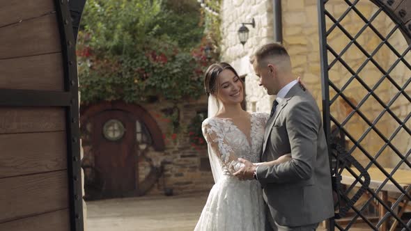 Lovely Newlyweds Caucasian Bride Embracing Groom in Park Making Kiss Wedding Couple Family Hugging