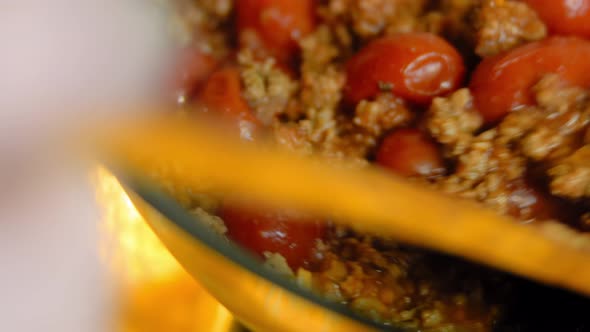 Mix the Ingredients for the Chorizo and the Preserved Tomatoes with a Wooden Spoon