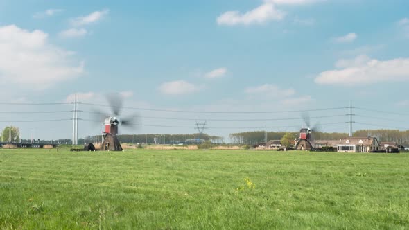 Dutch Windmills Spinning On The Field In The Netherlands On A Sunny Day. wide, time lapse