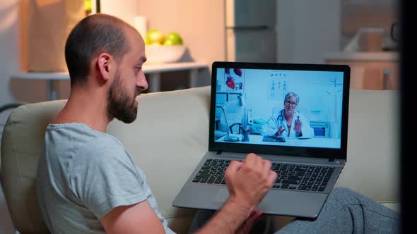 Caucasian Male Chatting with Physician Doctor During Online Telemedicine Consultation