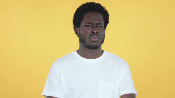 Disliking African Man Rejecting Offer Yellow Background