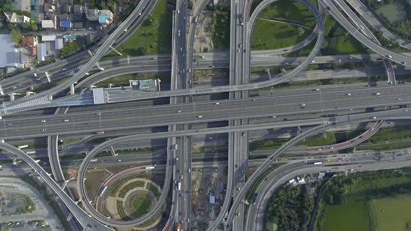 Aerial View of Highway Road Interchange with Busy Urban Traffic Speeding on Road