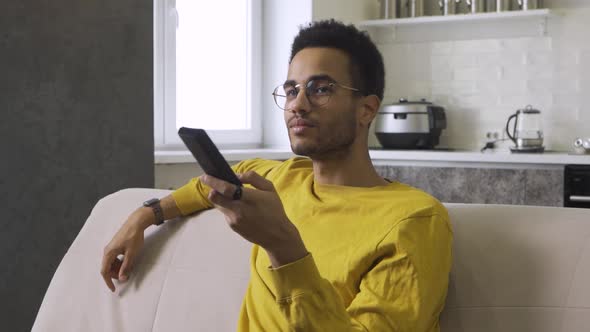 Africanamerican Young Man Watching Tv at Home