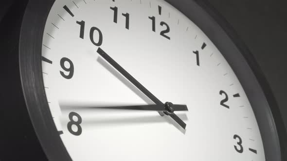 Clock Face In Time Lapse On Dark Grey Wall 